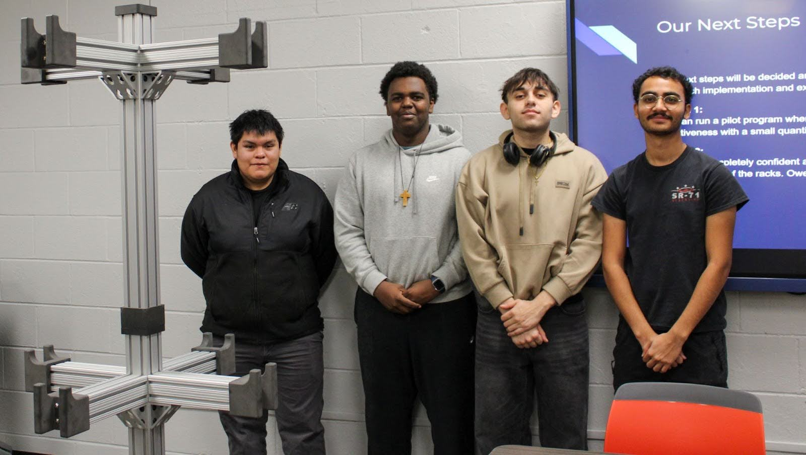 Students standing beside the fully constructed Orbit Rack.